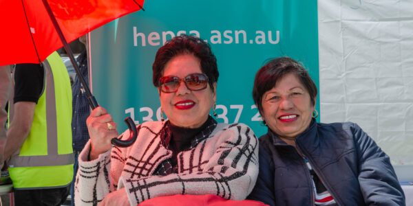 Filipino ladies with red umbrella at the hepSA stall at Filipino Fiesta