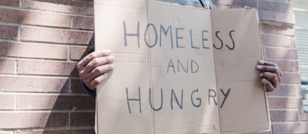 hands holding sign: Homeless and Hungry