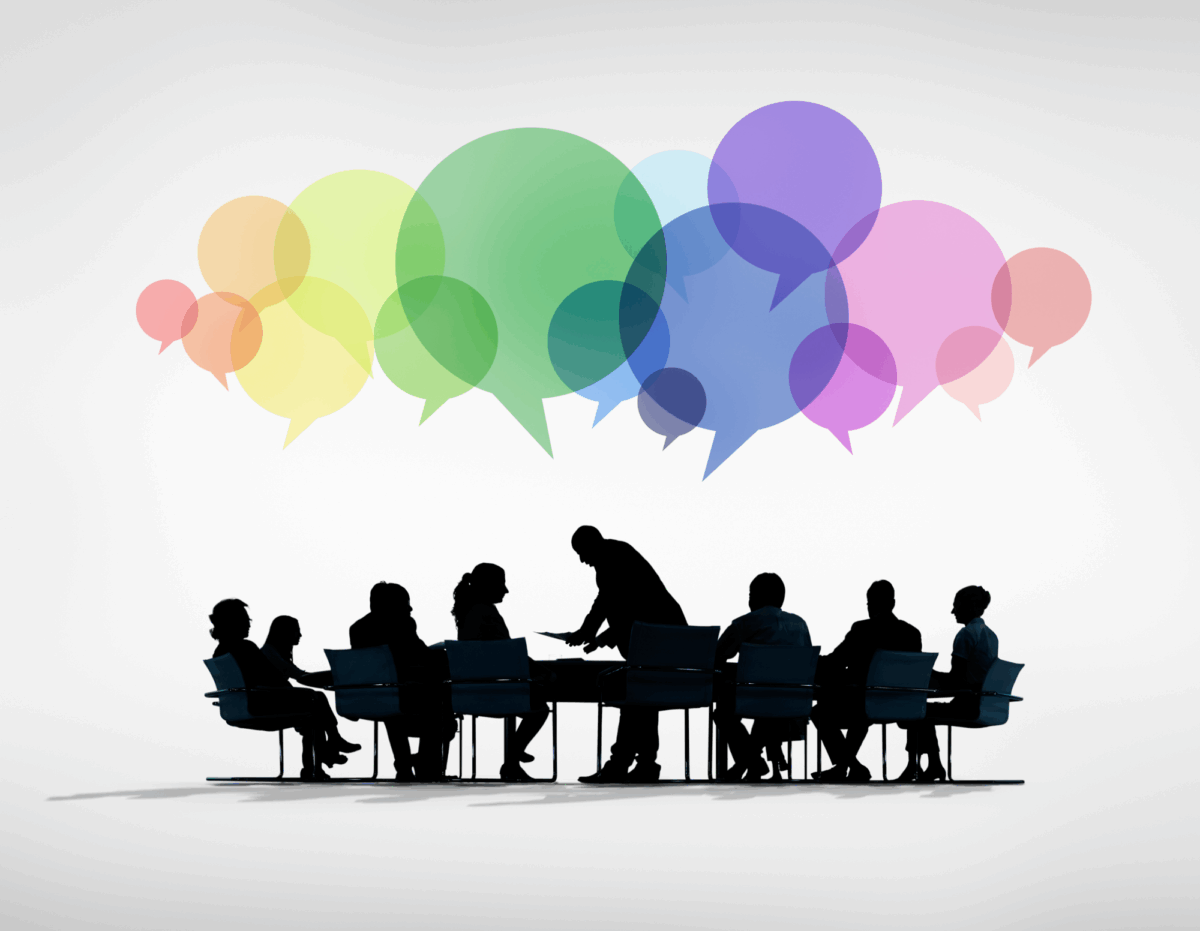 silhouetted group of people discussing something at a conference table, with multicoloured speech balloons hovering above their heads